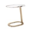 A luxury side table by Eichholtz with a marble top and brushed brass base