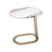A luxury side table by Eichholtz with a marble top and brushed brass base