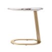 A luxury side table by Eichholtz with a marble top and brushed brass base