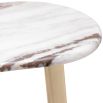 A luxury side table by Eichholtz with a marble top and brushed brass base