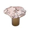 A stainless steel base with a brushed brass finish elegantly supports the asymmetrical marbled top.