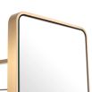 Floor mirror with rotating base and sleek coatrack wrapped in luxury brushed brass finish