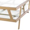 Square coffee table with geometric brass legs and glass top