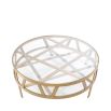 Circular coffee table with geometric brass legs and glass top