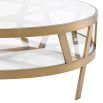 Circular coffee table with geometric brass legs and glass top