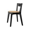 A rattan base dining chair with tapered legs and black frame