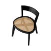 A rattan base dining chair with tapered legs and black frame