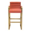 orange linen upholstered barstool with horizontal fluting and brass frame