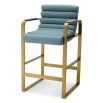 blue linen upholstered counter stool with horizontal fluting and brass frame