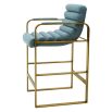 blue linen upholstered counter stool with horizontal fluting and brass frame