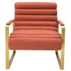 orange linen upholstered armchair with horizontal fluting and brass frame