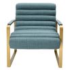 blue linen upholstered armchair with horizontal fluting and brass frame