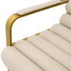 Cream linen upholstered bar stool with horizontal fluting and brass frame