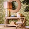 A round handwoven rattan mirror with a warm tone finish