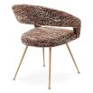 A stylish dining chair by Eichholtz with an open back and statement upholstery