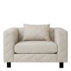 Grey upholstered modern armchair with chevron stitching detail