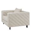 Grey upholstered modern armchair with chevron stitching detail