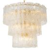 Divine and opulent chandelier featuring textured layered grass and brushed brass accents