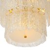 Divine and opulent chandelier featuring textured layered grass and brushed brass accents