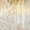 Divine and opulent chandelier featuring textured layered grass and brushed brass accents