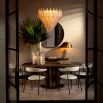 Tiered style chandelier featuring textured glass curved pieces forming an apex.