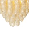 Tiered style chandelier featuring textured glass curved pieces forming an apex.