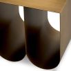 Modern side table with two curved legs finished in brushed brass