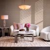 Off white sofa with curved back and a sleek black base