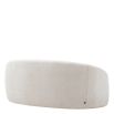 Off white sofa with curved back and a sleek black base