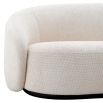 Off white sofa with curved back and a sleek black base