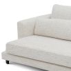 Slightly curved off-white sofa with sleek black feet.