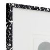 Black artistic wooden frame containing minimalist prints