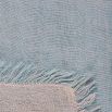 A handwoven linen throw in a pastel blue