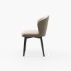 A luxurious dining chair upholstered in two sumptuous fabrics by Laskasas