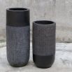 Elevate your decor with these black terracotta vases, blending earthy craftsmanship and modern design with woven accents for rustic elegance.