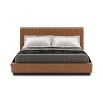 A luxurious leather bed with a fluted headboard and a wrought iron plinth