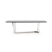 A chic dining table with a z-shaped base and a grey eucalyptus table top and stainless steel base