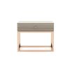 A modern grey bedside table with a gold base and details