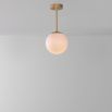 Industrial style glass globe pendant made entirely of solid brass and handblown glass globes with a natural brass finish