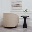 A luxurious linen upholstered swivel chair with accentuating piped details