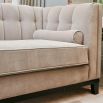 ex-display armchair in grey upholstery with fluting and deep stitching details
