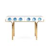 A futuristic white console table with blue acrylic cabochons and a polished brass base 