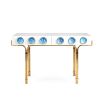 A futuristic white console table with blue acrylic cabochons and a polished brass base 