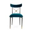 A luxurious vintage-style dining chair with polished brass accents and navy upholstery