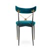 A luxurious vintage-style dining chair with polished brass accents and navy upholstery