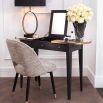 A luxurious, grey charcoal dressing table with brass details and a mirrored surface