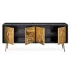 A brutalist inspired black and hand-hammered brass credenza 