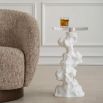 Artistic side table composed of white stone with circular glass top