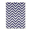 A bold blue and white reversible rug by Jonathan Adler with a zigzag pattern 