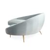 contemporary, curved sofa with velvet upholstery and golden legs
